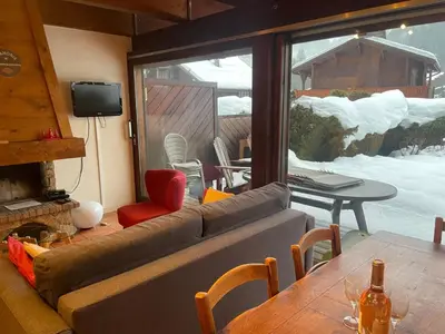 a living room with a couch and a table at Apartment Clos du Chantey Moury by Interhome in Chamonix-Mont-Blanc
