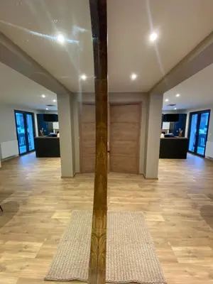 a room with a wooden door and a wooden floor at Appartement PISTE ROUGE in Les Houches