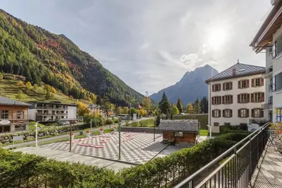 a view from a balcony of a town with mountains at Loriaz 12 - Appartement avec vue et piscine à deux pas du telecabine in Vallorcine