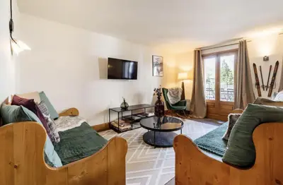 a living room with two beds and a couch at Loriaz 12 - Appartement avec vue et piscine à deux pas du telecabine in Vallorcine