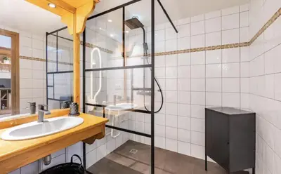 a bathroom with a sink and a glass shower at Loriaz 12 - Appartement avec vue et piscine à deux pas du telecabine in Vallorcine