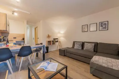 a living room with a couch and a table at Chamonix Sud - Jonquilles 209 - Happy Rentals in Chamonix-Mont-Blanc