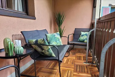 two chairs and a table on a balcony with pillows at Chamonix Sud - Jonquilles 209 - Happy Rentals in Chamonix-Mont-Blanc