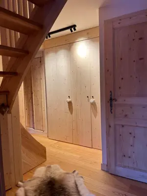 a dog laying on the floor in a room with a door at Chalet L'AS DE CARROZ in Arâches-la-Frasse