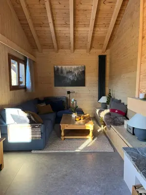a living room with a couch and a coffee table at Chalet L'AS DE CARROZ in Arâches-la-Frasse