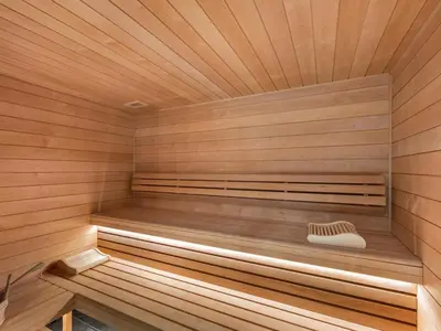 a wooden sauna with a bench in the middle at Appartement moderne avec accès sauna et hammam - FR-1-569-186 in Megève