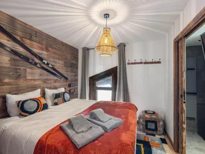 a bedroom with a bed with towels on it at Appartement moderne avec accès sauna et hammam - FR-1-569-186 in Megève