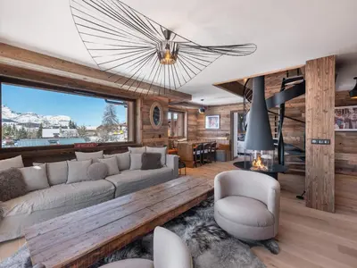 a living room with a couch and a fireplace at Appartement moderne avec accès sauna et hammam - FR-1-569-186 in Megève