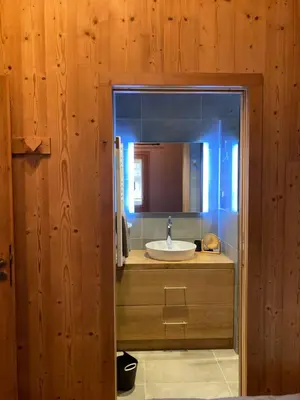 a bathroom with a sink and a mirror at Appartement Rêve de Montagne in Samoëns