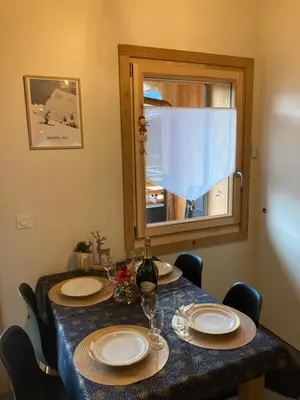 a table with two plates and a window at Appartement Rêve de Montagne in Samoëns
