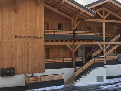 a building with wood panels and stairs on it at Appartement Rêve de Montagne in Samoëns