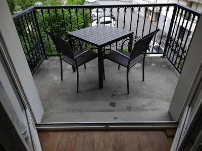 a table and two chairs on a balcony at Côté DÔMES in Saint-Gervais-les-Bains