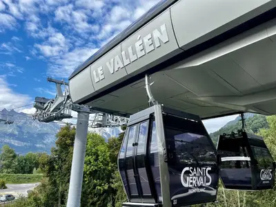 a gondola at a gas station with mountains in the background at Côté DÔMES in Saint-Gervais-les-Bains