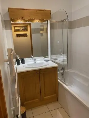 a bathroom with a sink and a shower at Côté DÔMES in Saint-Gervais-les-Bains