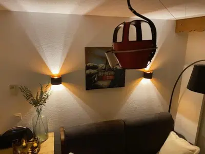a living room with a couch and a basketball on the wall at Côté DÔMES in Saint-Gervais-les-Bains