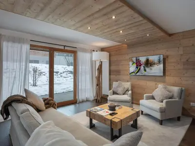 a living room with a couch and chairs and a table at Appartement spacieux à Megève, 3 ch, près des pistes, parking privé - FR-1-569-139 in Megève
