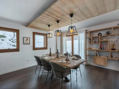 a dining room with a wooden table and chairs at Appartement spacieux à Megève, 3 ch, près des pistes, parking privé - FR-1-569-139 in Megève