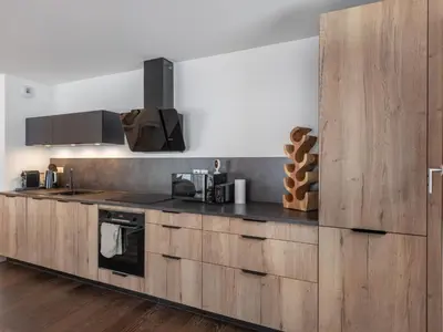a kitchen with wooden cabinets and a counter top at Appartement spacieux à Megève, 3 ch, près des pistes, parking privé - FR-1-569-139 in Megève