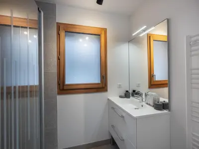 a bathroom with a sink and a mirror at Appartement spacieux à Megève, 3 ch, près des pistes, parking privé - FR-1-569-139 in Megève