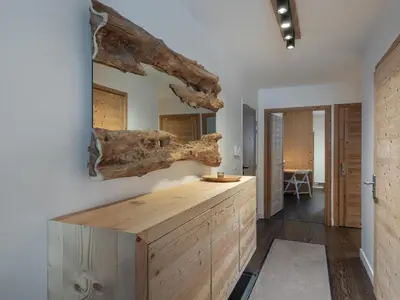 a kitchen with a wooden counter with a tree branch on the wall at Appartement spacieux à Megève, 3 ch, près des pistes, parking privé - FR-1-569-139 in Megève
