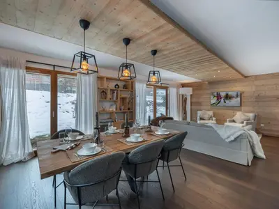 a dining room and living room with a table and chairs at Appartement spacieux à Megève, 3 ch, près des pistes, parking privé - FR-1-569-139 in Megève