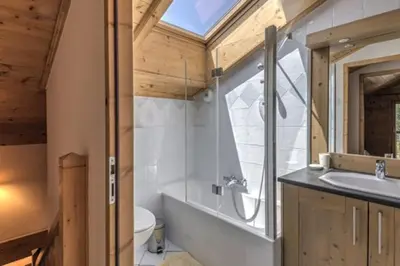 a bathroom with a sink and a toilet and a window at Le Chardon Argenté T4 Duplex 4 etoiles - 7 couchages - Parking&Piscine in Samoëns