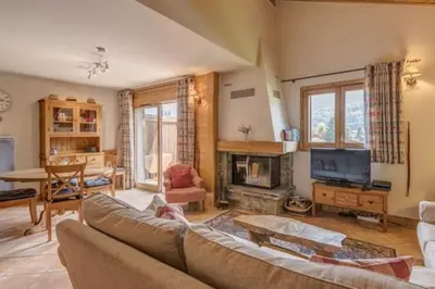 a living room with a couch and a fireplace at Le Chardon Argenté T4 Duplex 4 etoiles - 7 couchages - Parking&Piscine in Samoëns