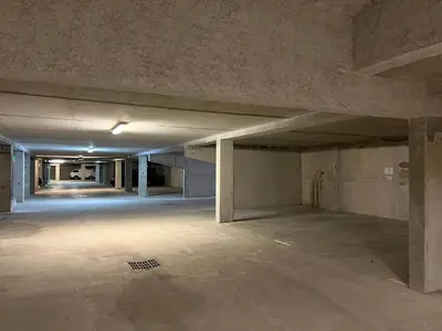 an empty parking lot in an empty parking garage at Le Chardon Argenté T4 Duplex 4 etoiles - 7 couchages - Parking&Piscine in Samoëns