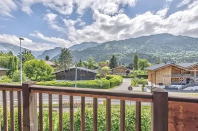 a view from the deck of a home with mountains in the background at Le Chardon Argenté T4 Duplex 4 etoiles - 7 couchages - Parking&Piscine in Samoëns