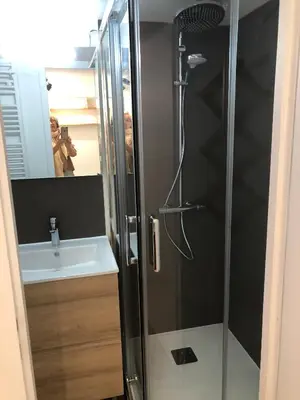 a person taking a picture of a shower in a bathroom at Chalet de charme aux Carroz d'Arrâches-Flaines in Les Carroz d'Araches