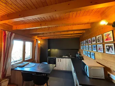 a kitchen with a table and a microwave in a room at Chalet de charme aux Carroz d'Arrâches-Flaines in Les Carroz d'Araches