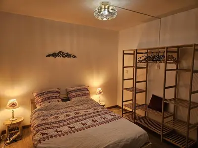 a bedroom with a bed and a book shelf at Appartement Cosy, Vue Mont Blanc, Plein Centre in Chamonix-Mont-Blanc