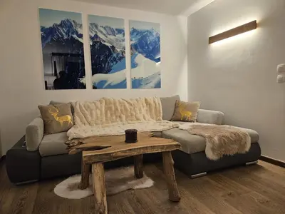 a living room with a couch and a coffee table at Appartement Cosy, Vue Mont Blanc, Plein Centre in Chamonix-Mont-Blanc