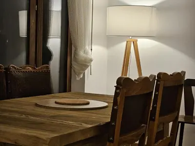 a dining room table with a lamp and chairs at Appartement Cosy, Vue Mont Blanc, Plein Centre in Chamonix-Mont-Blanc