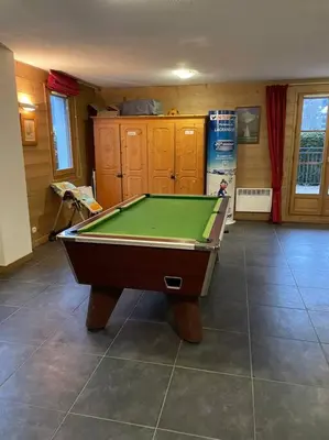 a living room with a pool table in it at Charmant appartement T3 avec magnifique vue in Saint-Gervais-les-Bains