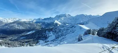 a snow covered mountain with trees and mountains at Charmant appartement T3 avec magnifique vue in Saint-Gervais-les-Bains