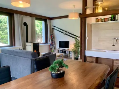 a living room with a table and a couch at Chalet la Pagode, vue Mont-Blanc et jardin privé in Chamonix-Mont-Blanc