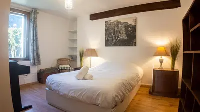 a bedroom with a large white bed in a room at Chalet la Pagode, vue Mont-Blanc et jardin privé in Chamonix-Mont-Blanc