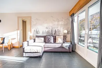 a bedroom with a bed and a large window at Les Tussilages - Terrasse vue Mont-Blanc in Chamonix-Mont-Blanc