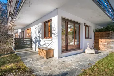 a front porch of a white house with a bench at Les Tussilages - Terrasse vue Mont-Blanc in Chamonix-Mont-Blanc