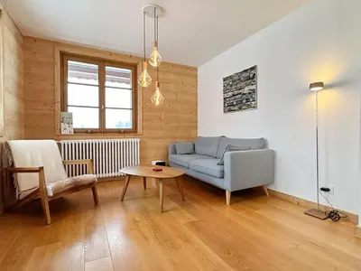 a living room with a blue couch and a table at Appartement T4 au calme avec jardin et wifi, proche du centre et ski-bus - FR-1-624-150 in Samoëns