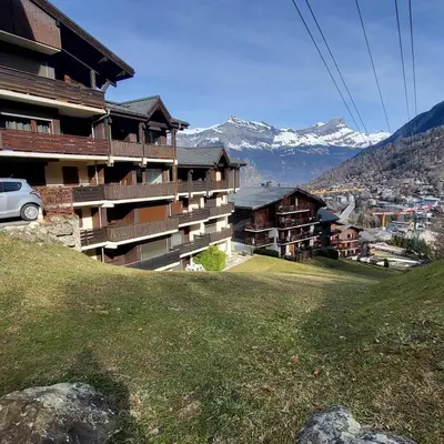 a white van parked in a parking lot next to a building at Hike, Bike, Ski, open the door and Go! in Saint-Gervais-les-Bains