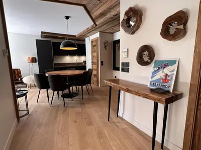 a kitchen and dining room with a table and chairs at Appartement de standing 3P au pied des pistes, terrase privée, parking, à 350m du centre-village - FR-1-572-294 in Arâches-la-Frasse