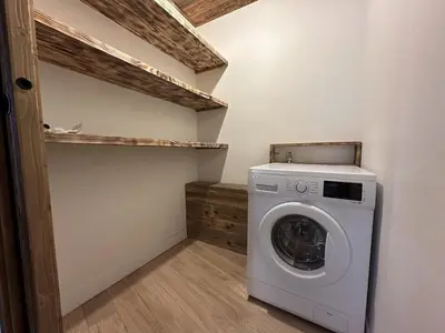 a washer and dryer in a laundry room at Appartement de standing 3P au pied des pistes, terrase privée, parking, à 350m du centre-village - FR-1-572-294 in Arâches-la-Frasse