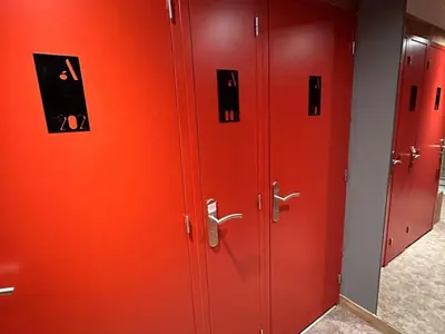 a row of red lockers with pictures on them at Appartement de standing 3P au pied des pistes, terrase privée, parking, à 350m du centre-village - FR-1-572-294 in Arâches-la-Frasse