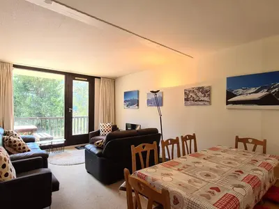 a living room with a couch and a table at Appartement spacieux au pied des pistes avec balcon et WIFI - FR-1-425-212 in Arâches-la-Frasse