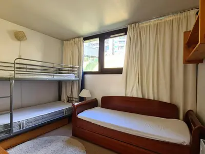 a bedroom with two bunk beds and a window at Appartement spacieux au pied des pistes avec balcon et WIFI - FR-1-425-212 in Arâches-la-Frasse