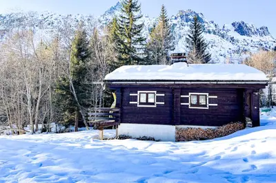 a small cabin with snow on top of it at Snowflake cottage with garden in Chamonix-Mont-Blanc
