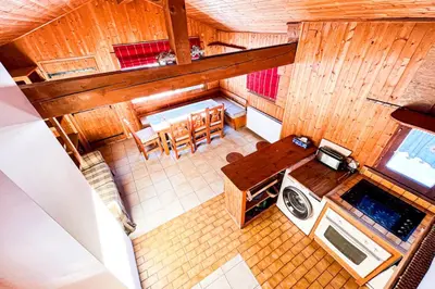 an overhead view of a kitchen and dining room at Snowflake cottage with garden in Chamonix-Mont-Blanc