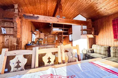 a dining room and kitchen in a log cabin at Snowflake cottage with garden in Chamonix-Mont-Blanc